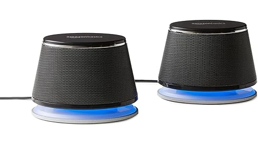 The image shows a collection of sleek, compact speakers arranged attractively, ideal for enhancing Macbook audio.
